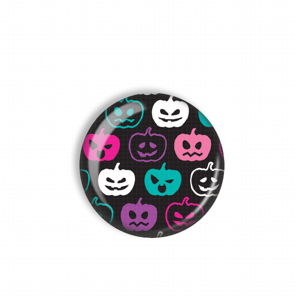 A round, black plate with a repeating pattern of white pumpkins in various colors, including pink, purple, and teal, against a black background.