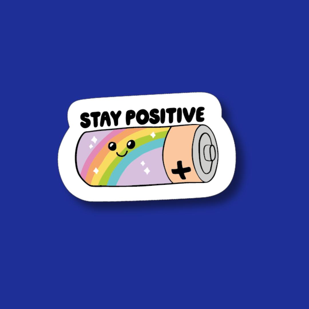 A sticker with a rainbow-colored battery and the text "STAY POSITIVE" on a blue background.