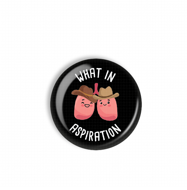 A black button with a cartoon image of two pink lungs wearing cowboy hats and the text "WHAT IN ASPIRATION" printed on it.