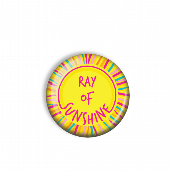 A round, colorful button with the text "Ray of Sunshine" written on it.