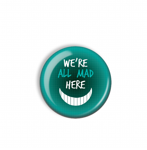 A teal-colored button with the text "WE'RE ALL MAD HERE" printed on it.