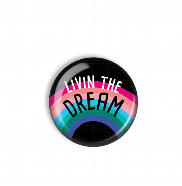 A colorful button with the text "LIVIN THE DREAM" on it.