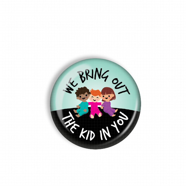 A round button with a cartoon image of three children, two girls and one boy, sitting together. The text on the button reads "WE BRING OUT THE KID IN YOU".