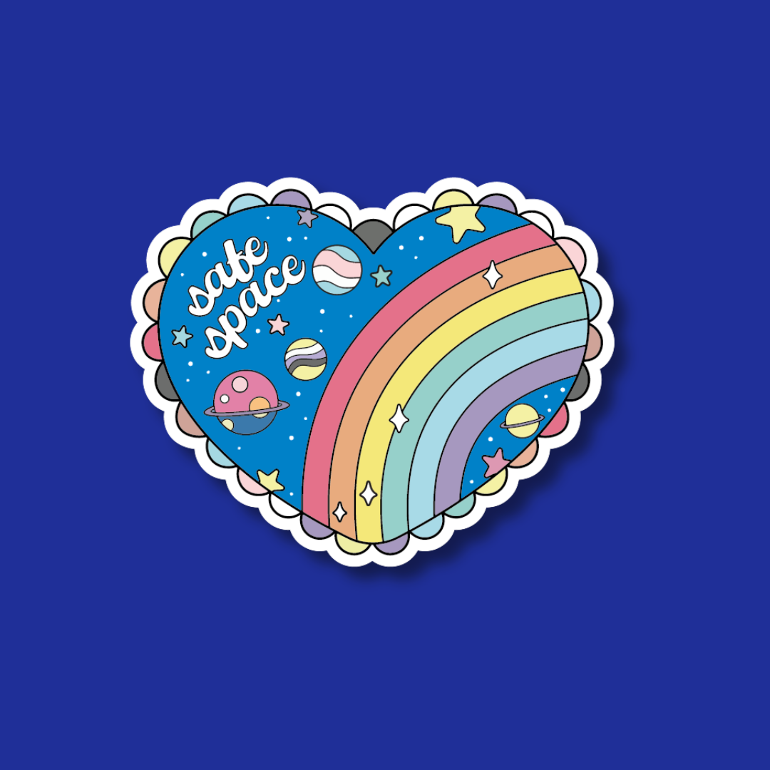 A heart-shaped sticker with a rainbow and stars, along with the text "safe space" written on it, against a blue background.