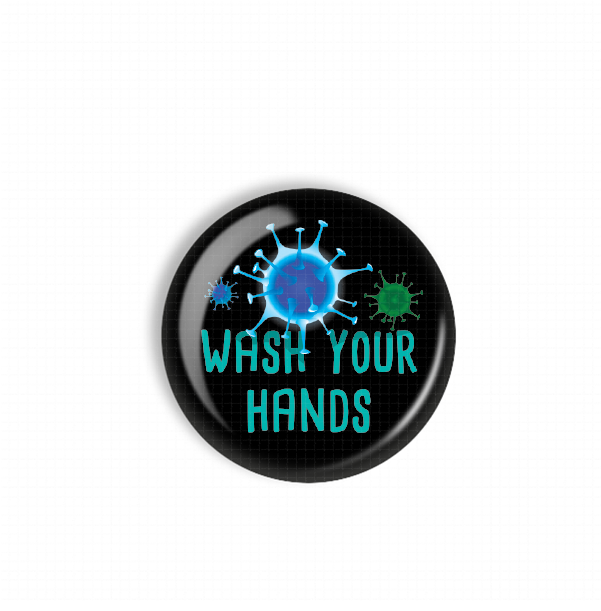 A black button with a blue and green design featuring a virus-like shape and the text "WASH YOUR HANDS" printed on it.
