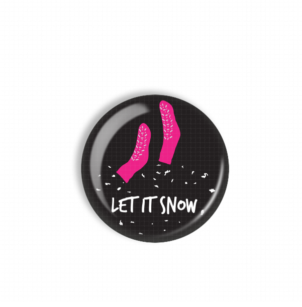 A black circular button with a pink sock and the text "LET IT SNOW" printed on it.